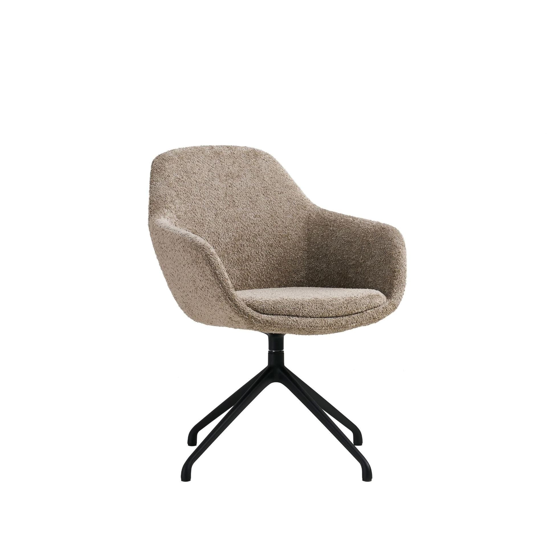 Low-backed tub-style bucket chair being cleaned with upholstery extraction equipment