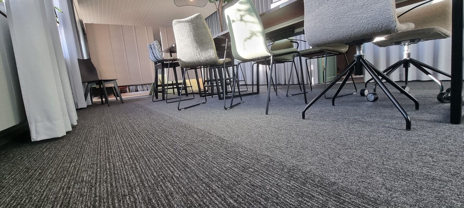 Van-mounted carpet cleaning machine extracting dirt from commercial carpet