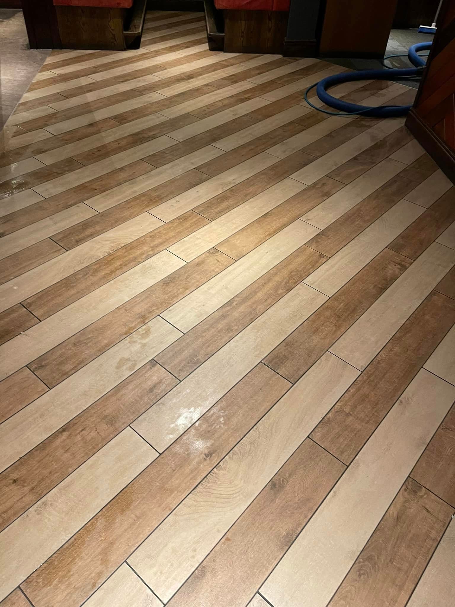 Wood-effect laminate floor gleaming after professional cleaning service