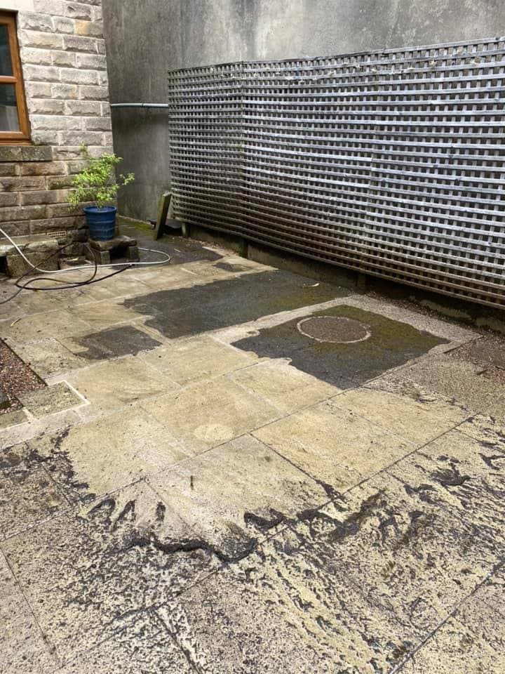 High-pressure washing cleaning a commercial paved outdoor area or beer garden